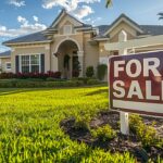 Florida home with a "For Sale" sign in front yard.